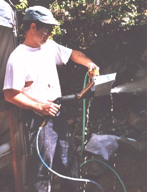 A picture of me testing the sprayer with some water (just after constructing the sprayer).